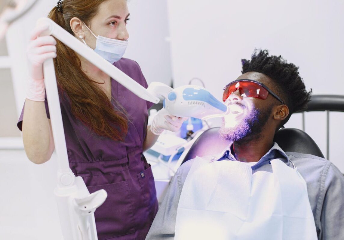 Dentist Whitening Mans Teeth