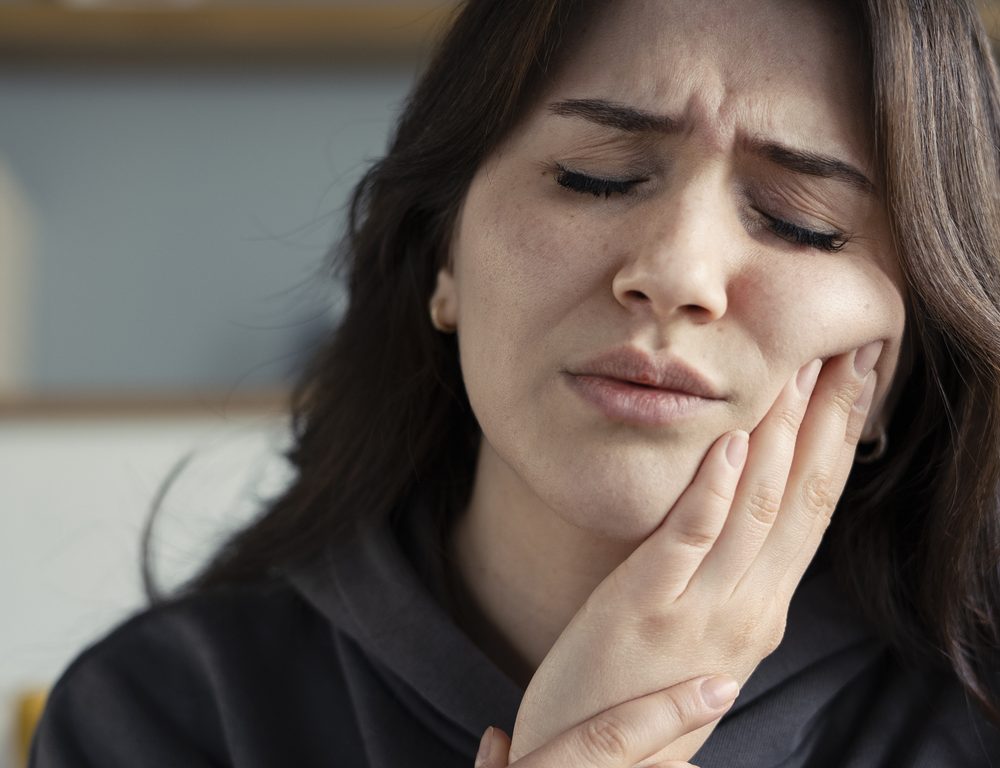 Woman suffering toothache at home