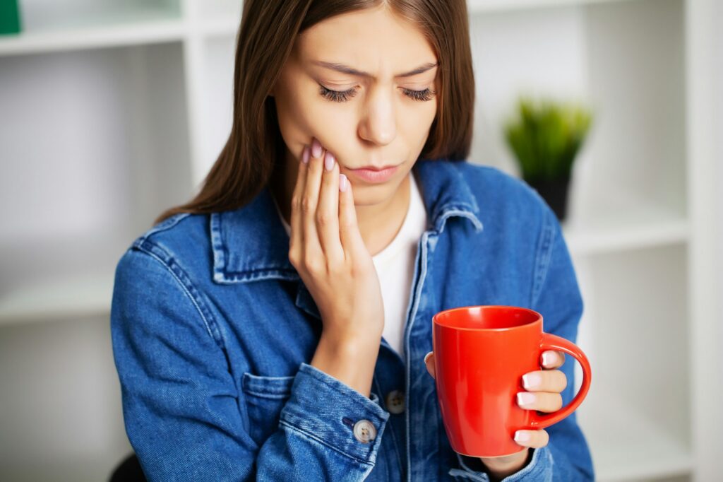 woman suffering from tooth cavities