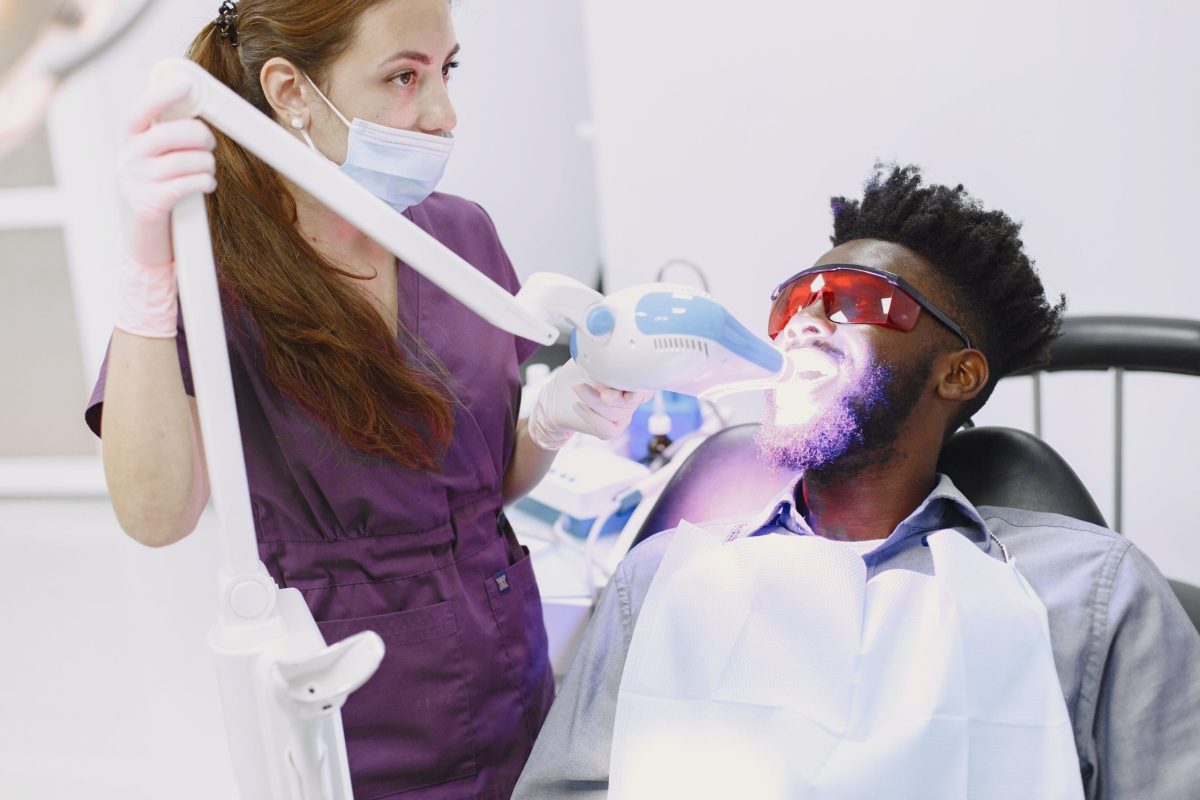 Dentist Whitening Mans Teeth