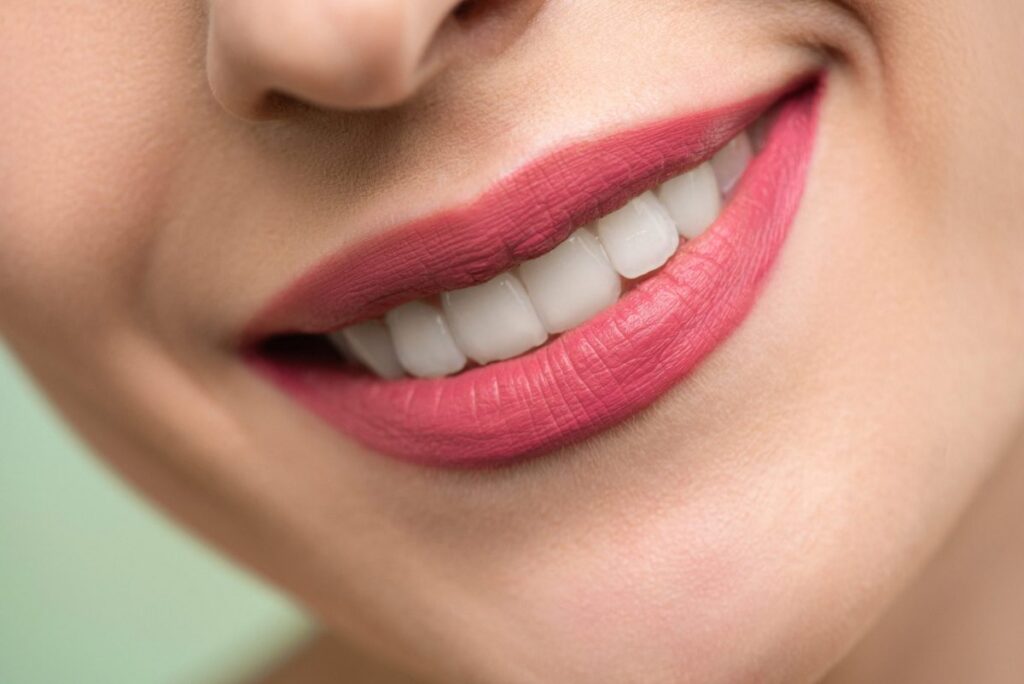 Woman With Red Lipstick and White Teeth Smiling