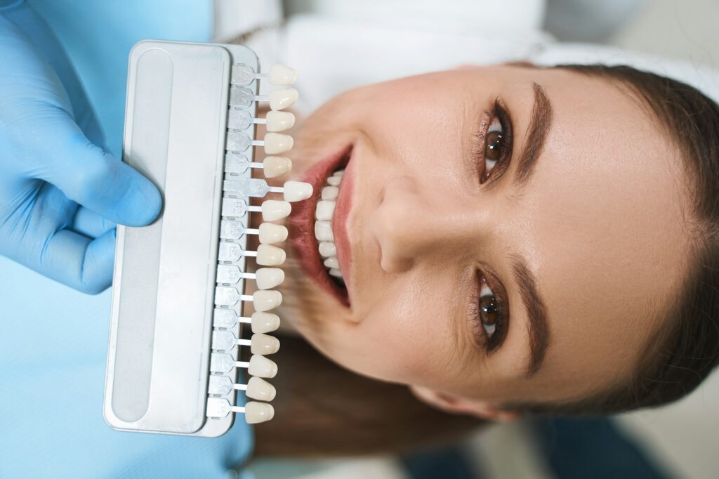 Smiling woman is choosing veneers stock photo